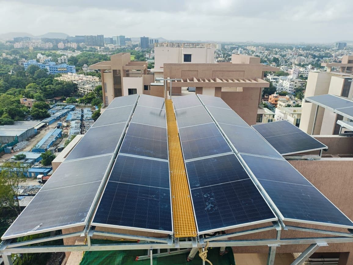 Raised solar structure covering the rooftop of a residential society building